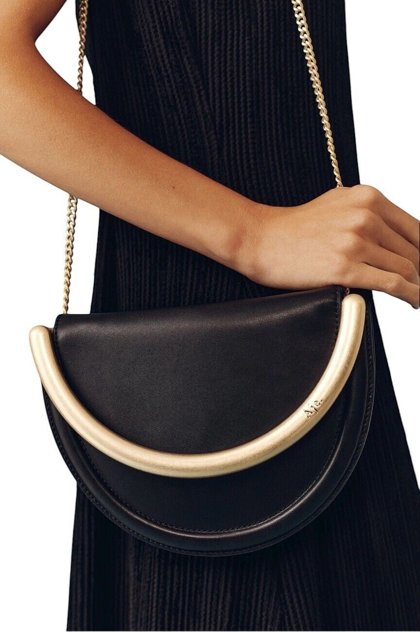 Naked Pear Aje Norma crescent crossbody bag in black leather with a gold metal handle and chain strap