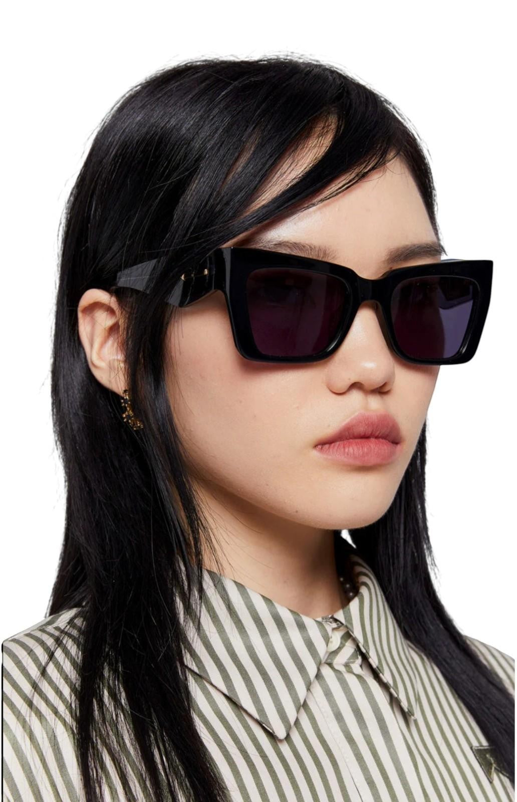 Model wearing Naked Pear Karen Walker Immortalised square cat-eye sunglasses with black acetate frames and smoke lenses