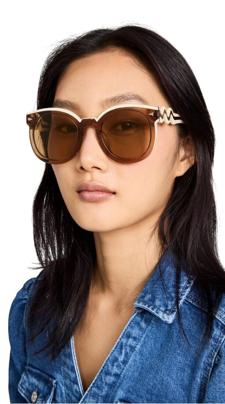 Naked Pear Karen Walker Super Wavy Duper sunglasses with round ochre and white frames and tan mono lenses on a model.