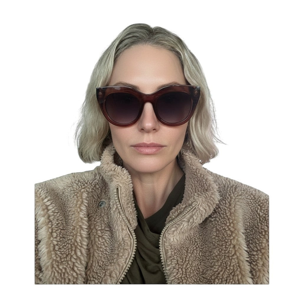 Naked Pear Le Specs Air Heart cat eye sunglasses in smokey pink transparent acetate worn by a woman
