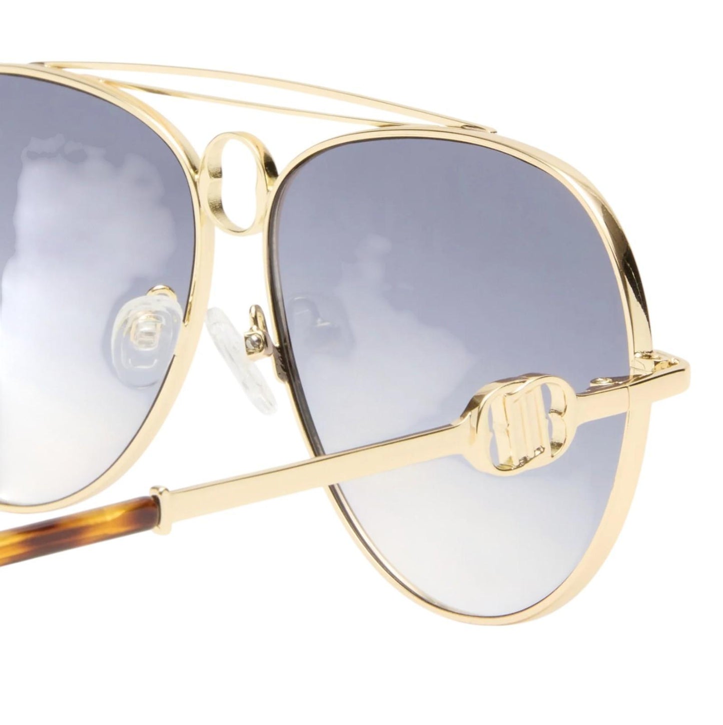 Gold-framed sunglasses with gray lenses on a white background