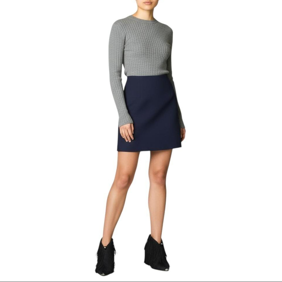 AI generated image of Woman wearing a gray sweater and navy skirt on a white background