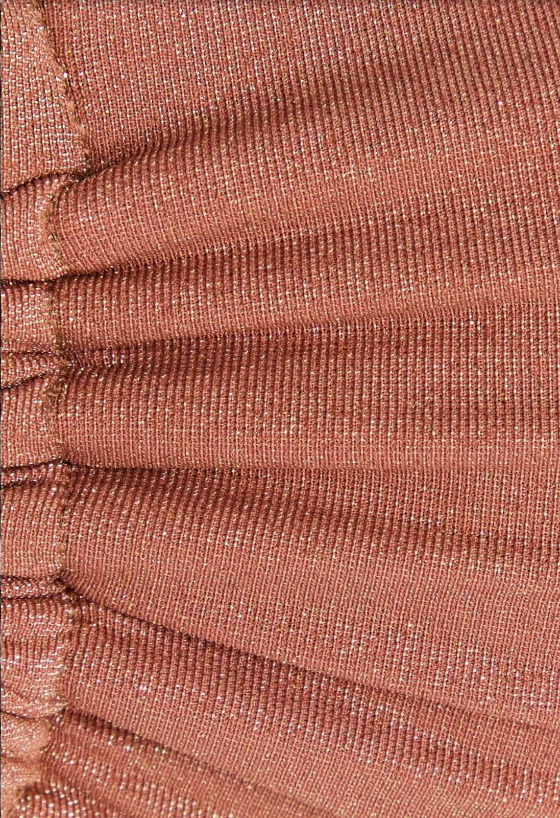 Close-up of pleated fabric with a rose gold color.