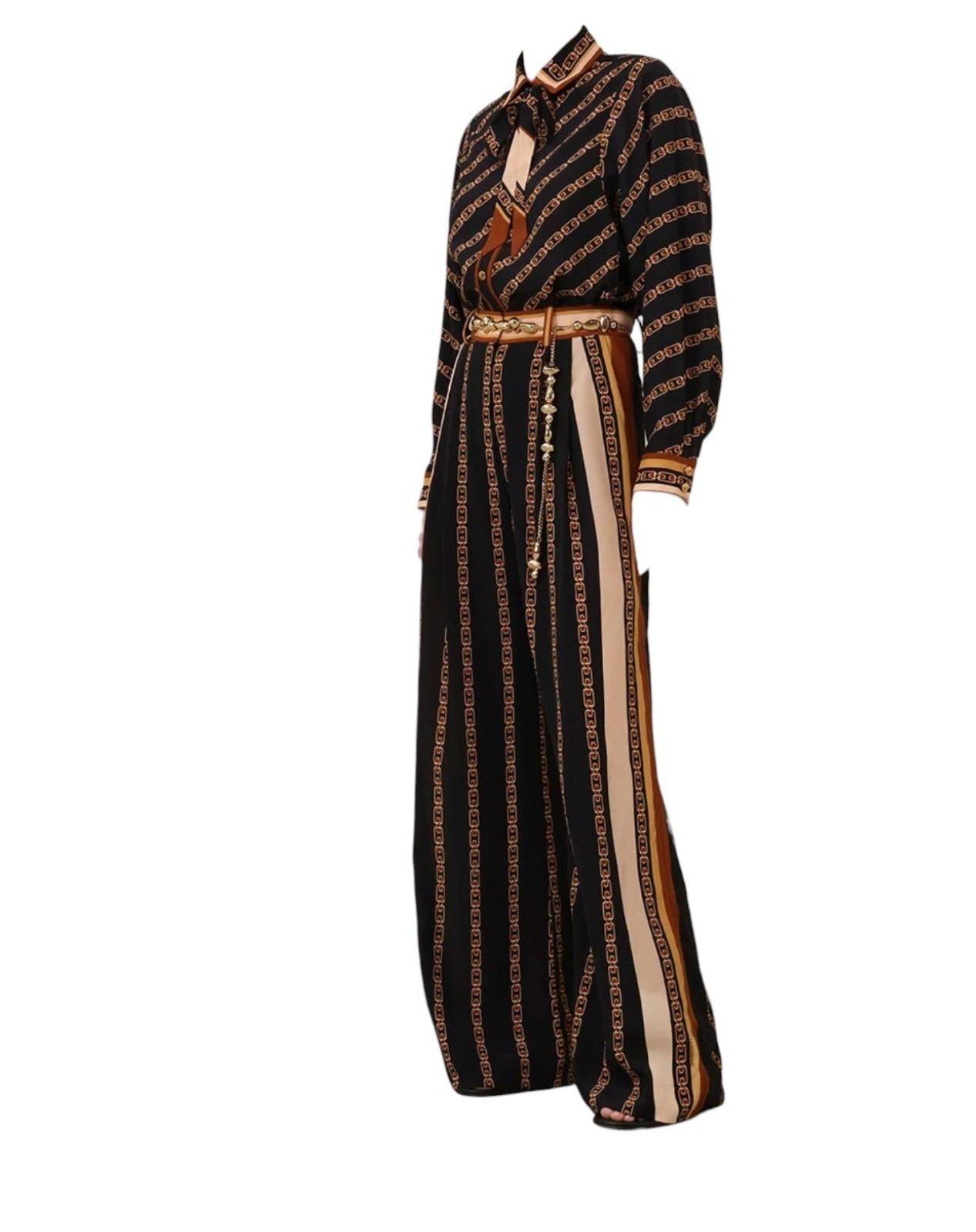 Long black dress with gold and white patterns on a white background