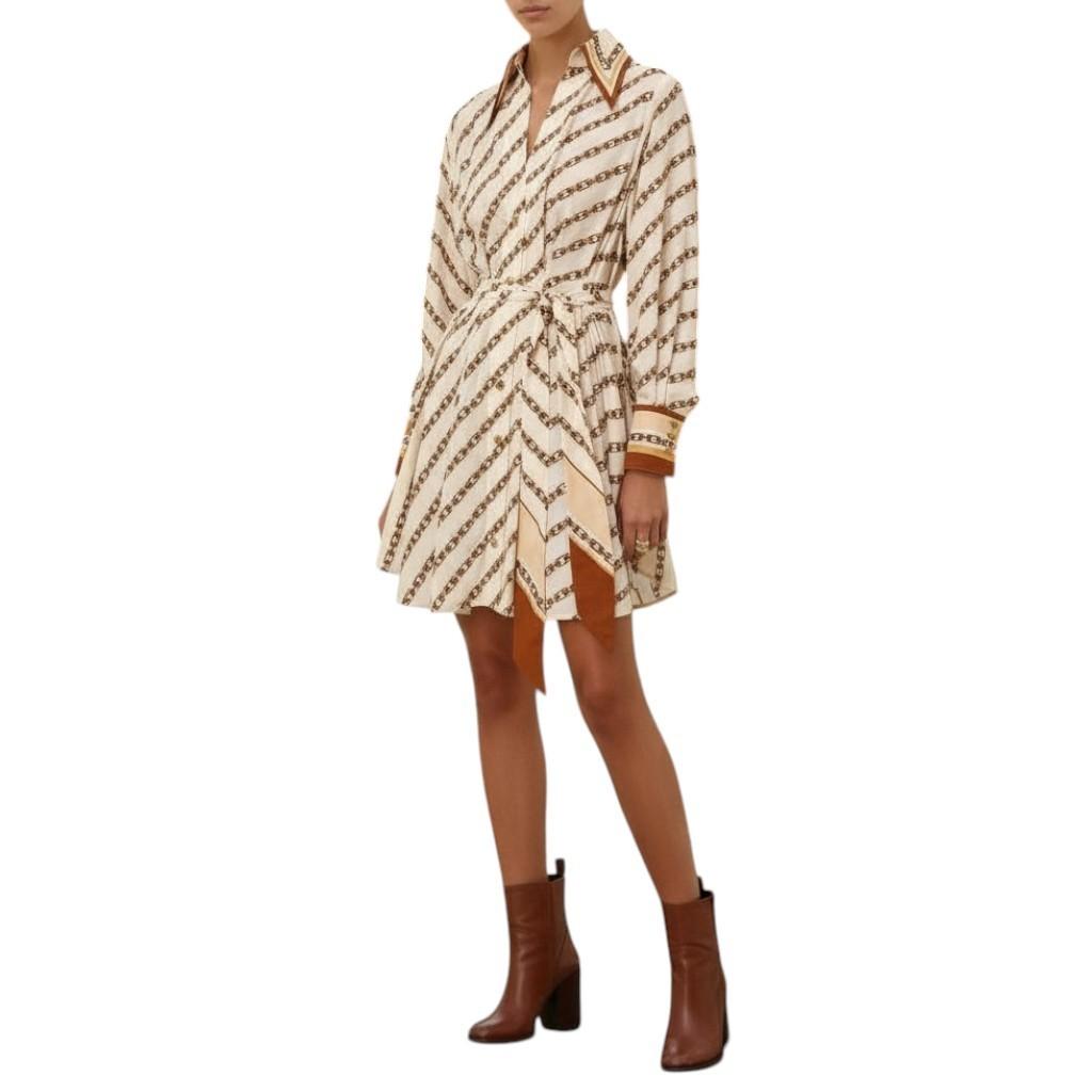 Beige and brown patterned dress with brown boots on a white background