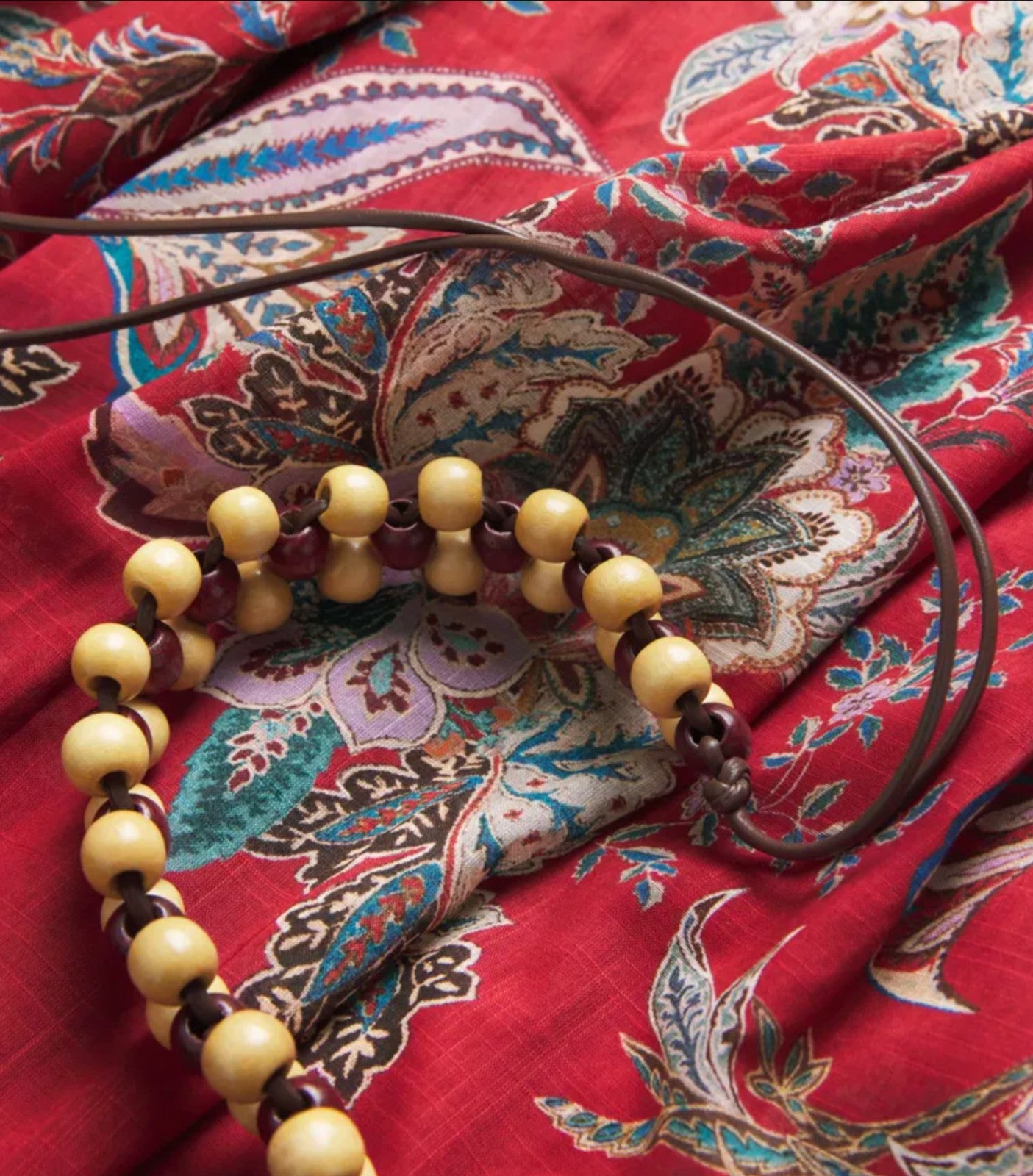 Naked Pear Zimmermann Rhiannon red paisley cotton fabric detail with a wooden bead belt accessory