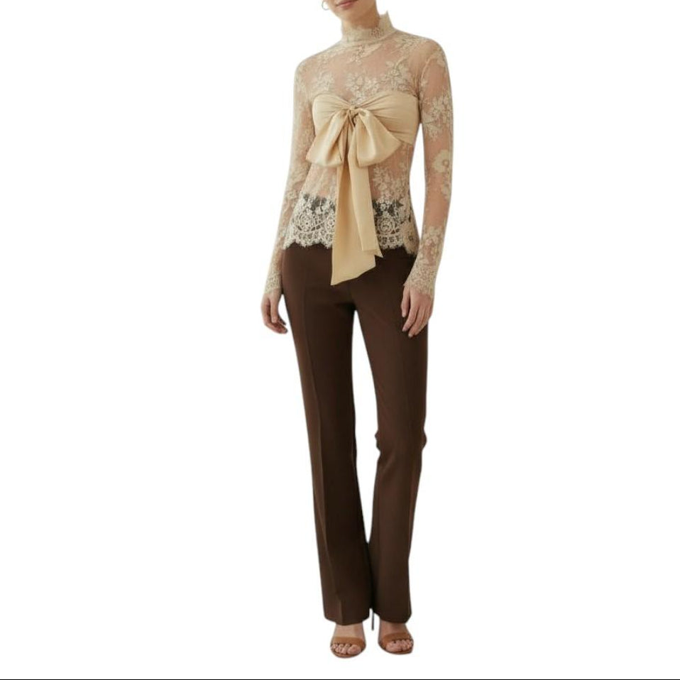 AI generated image of Woman wearing a beige lace top with a bow and brown pants on a white background