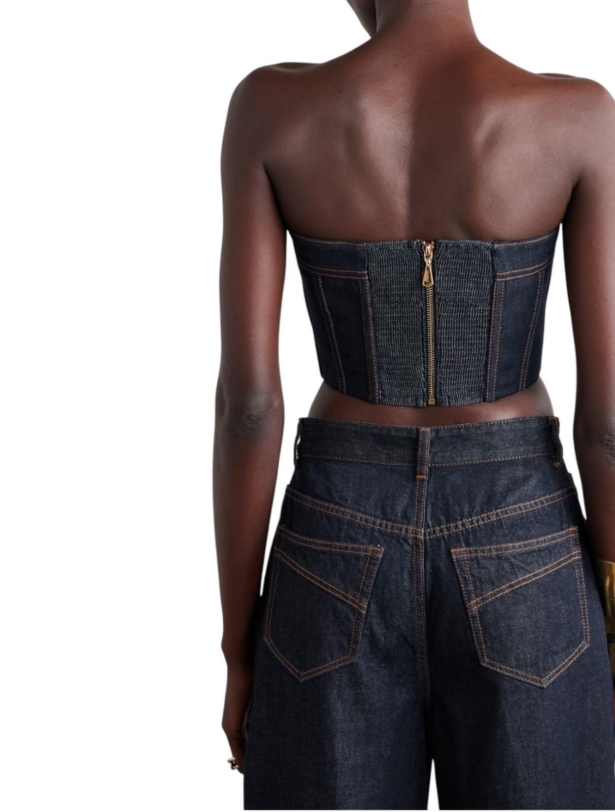 Denim outfit with a strapless top and high-waisted pants on a white background