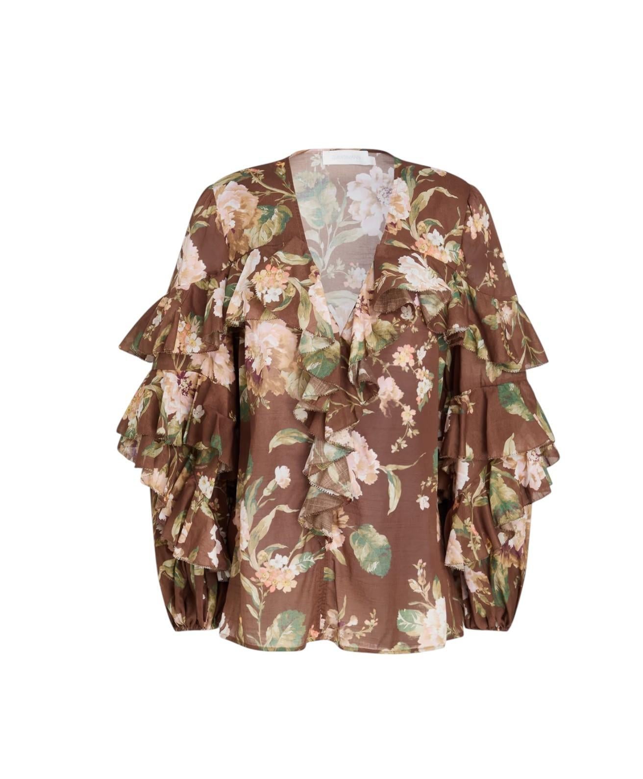 Floral patterned blouse with ruffled sleeves on a white background