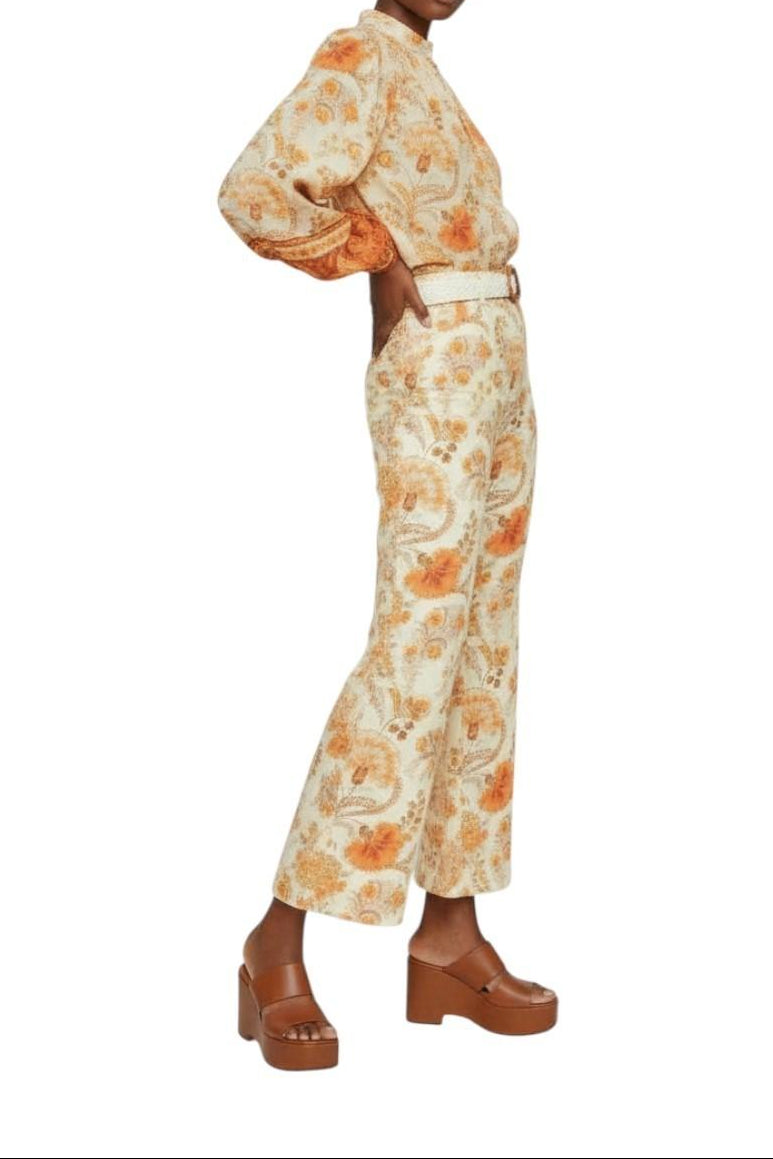 AI generated image of Woman wearing a floral outfit with brown shoes on a white background