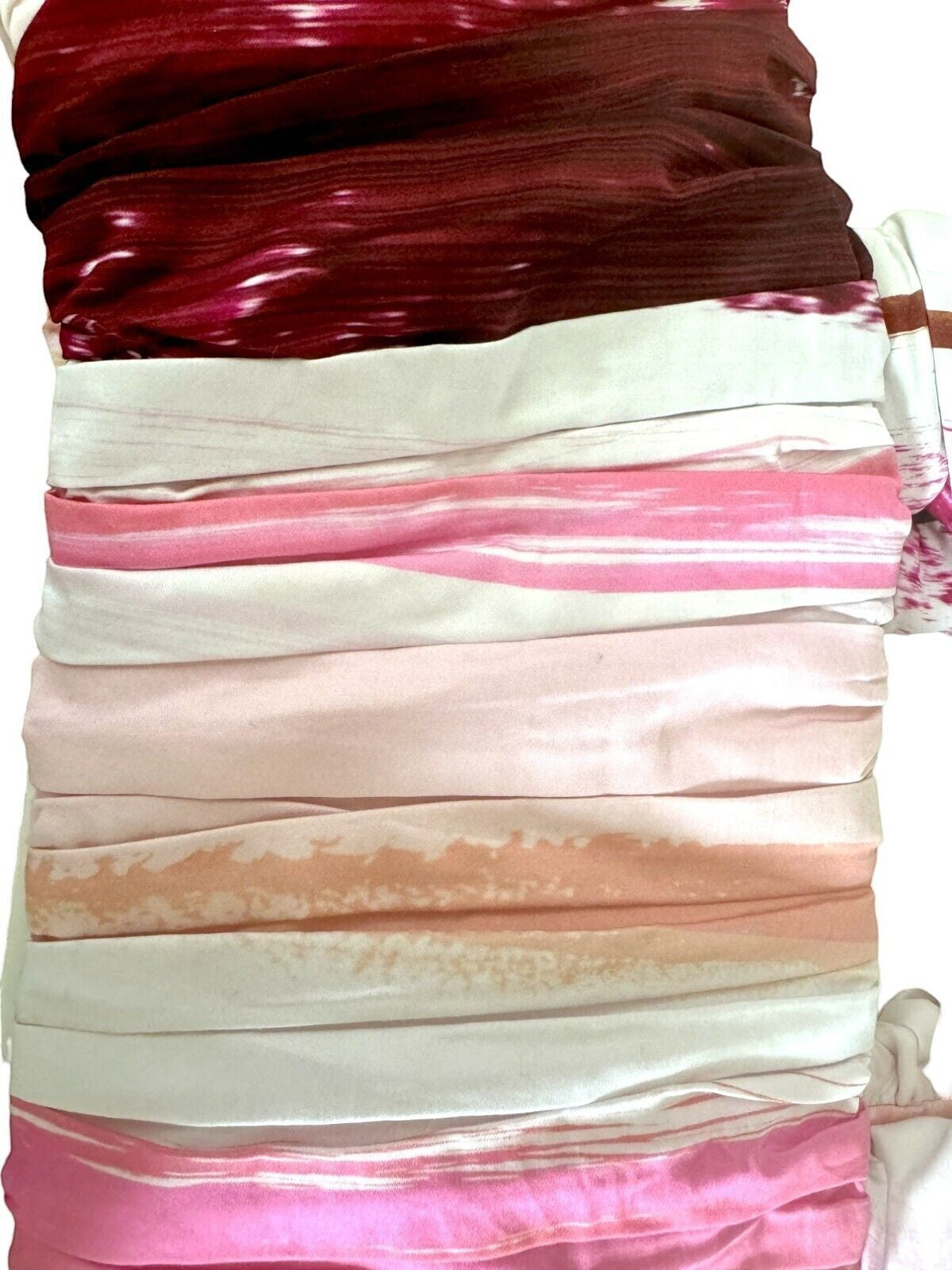 Naked Pear AJE Kasbah cotton crop top featuring sunset stripe ruching in pink, burgundy, and white tones.
