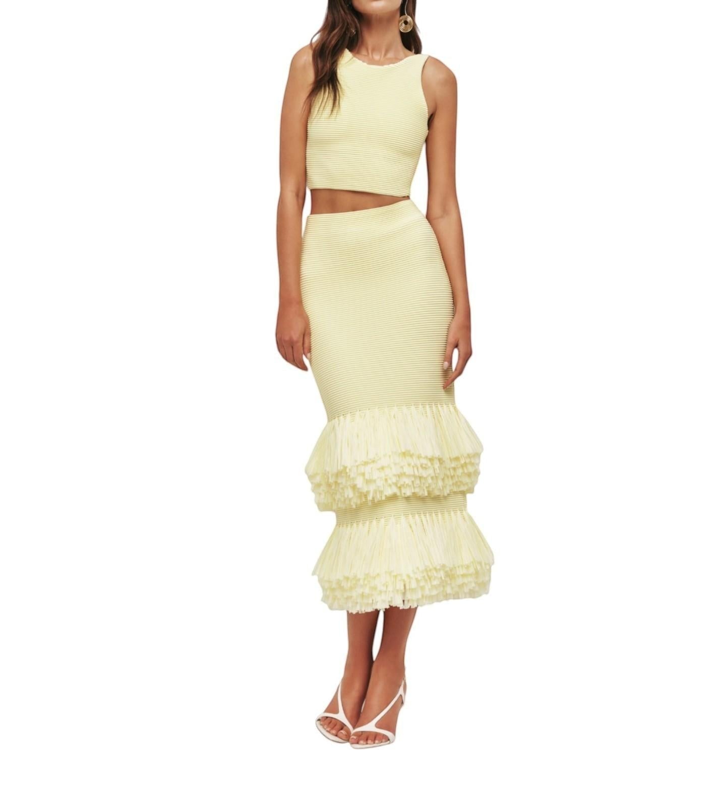 Naked Pear Aje Agave lemon yellow ribbed knit midi skirt with layered raffia trim hem worn by a model