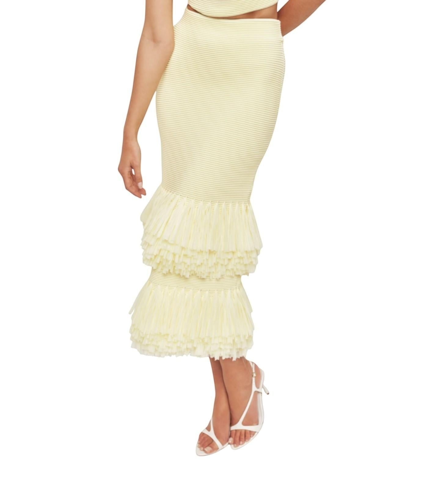Naked Pear Aje Agave lemon yellow ribbed knit midi skirt with layered raffia trim hem on a model
