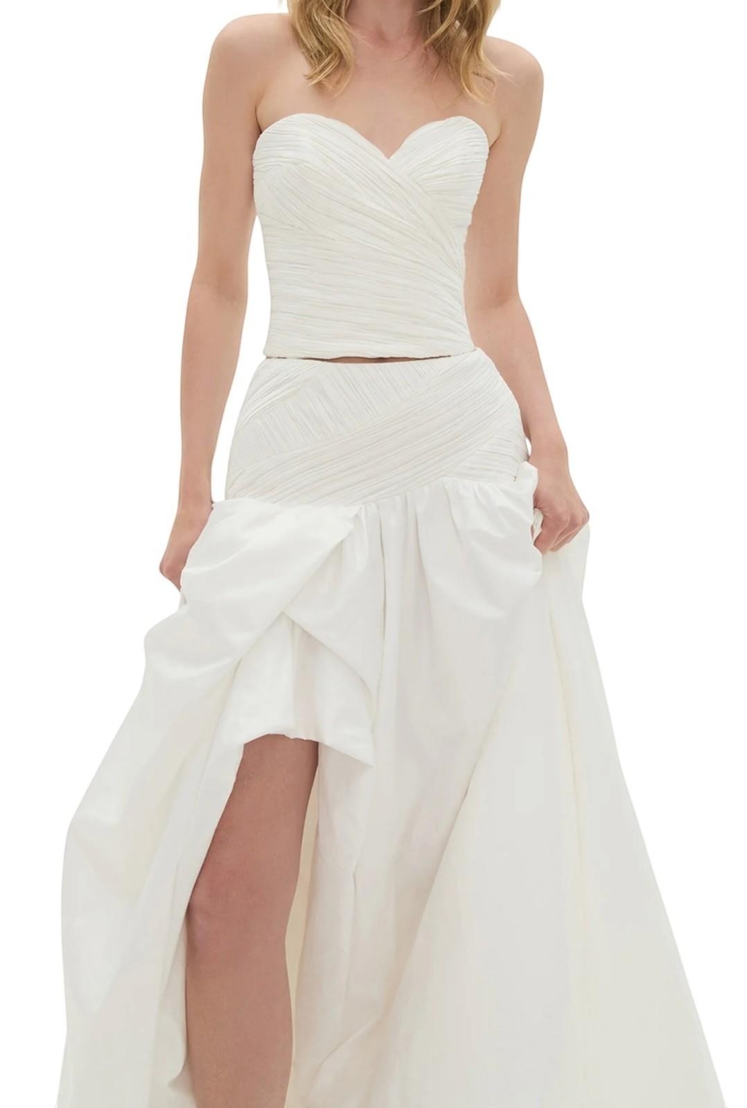 Naked Pear Aje Constellation ivory cotton midi skirt with ruched waist, bubble hem, and front slit on a model
