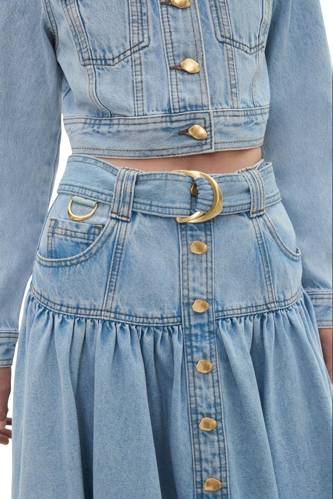 Naked Pear Aje Elena light blue denim midi skirt with high waist, D-ring belt, and gold button details.