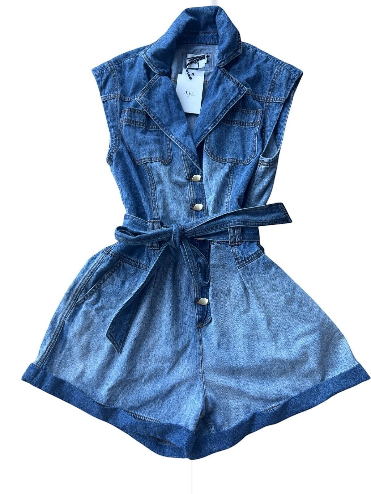 Naked Pear Aje Ines two-toned panelled denim playsuit with collar, gold buttons, and matching tie belt.