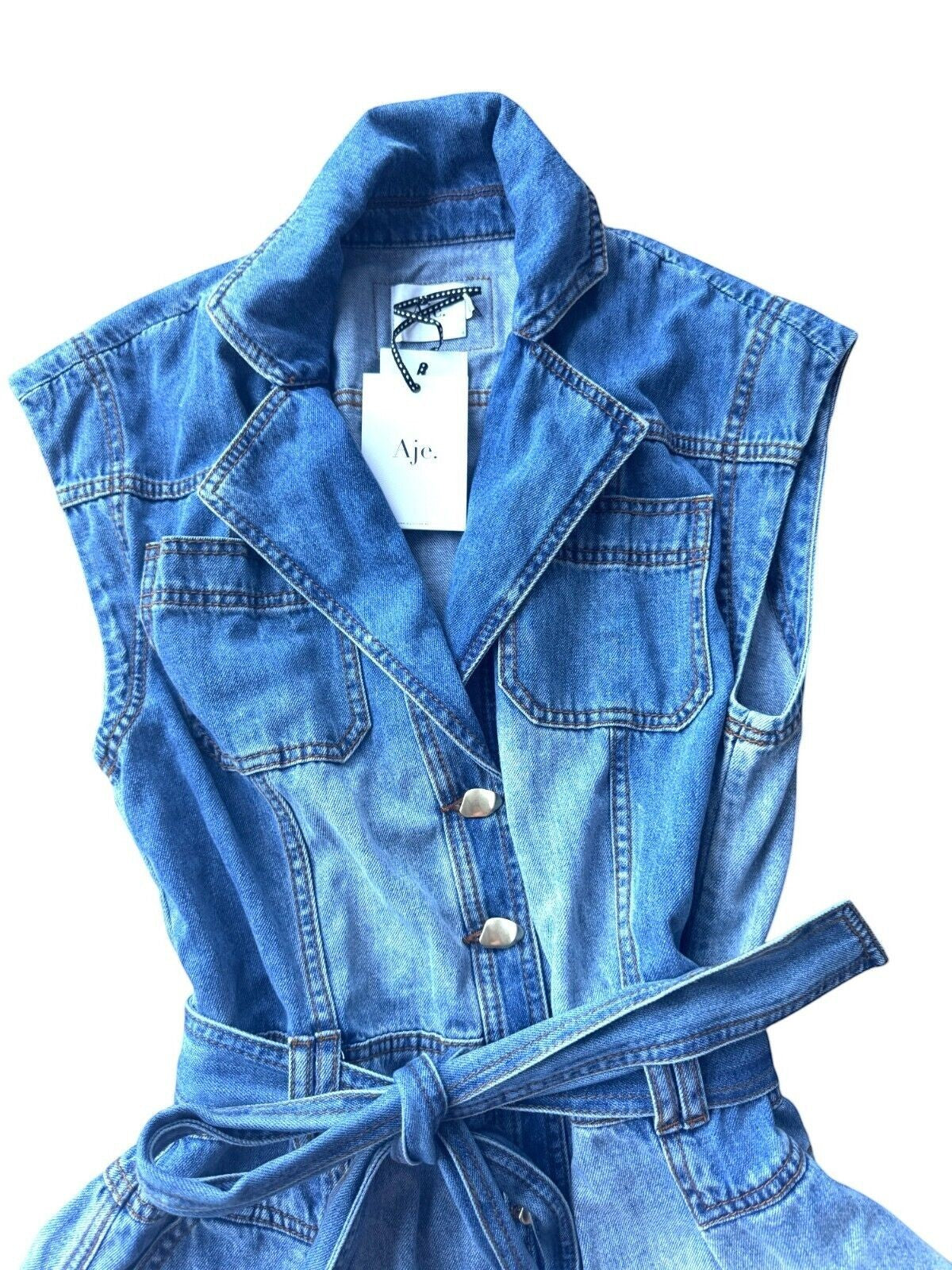 Naked Pear Aje Ines two-toned blue denim playsuit with collar, sculptural gold buttons, and matching tie belt.