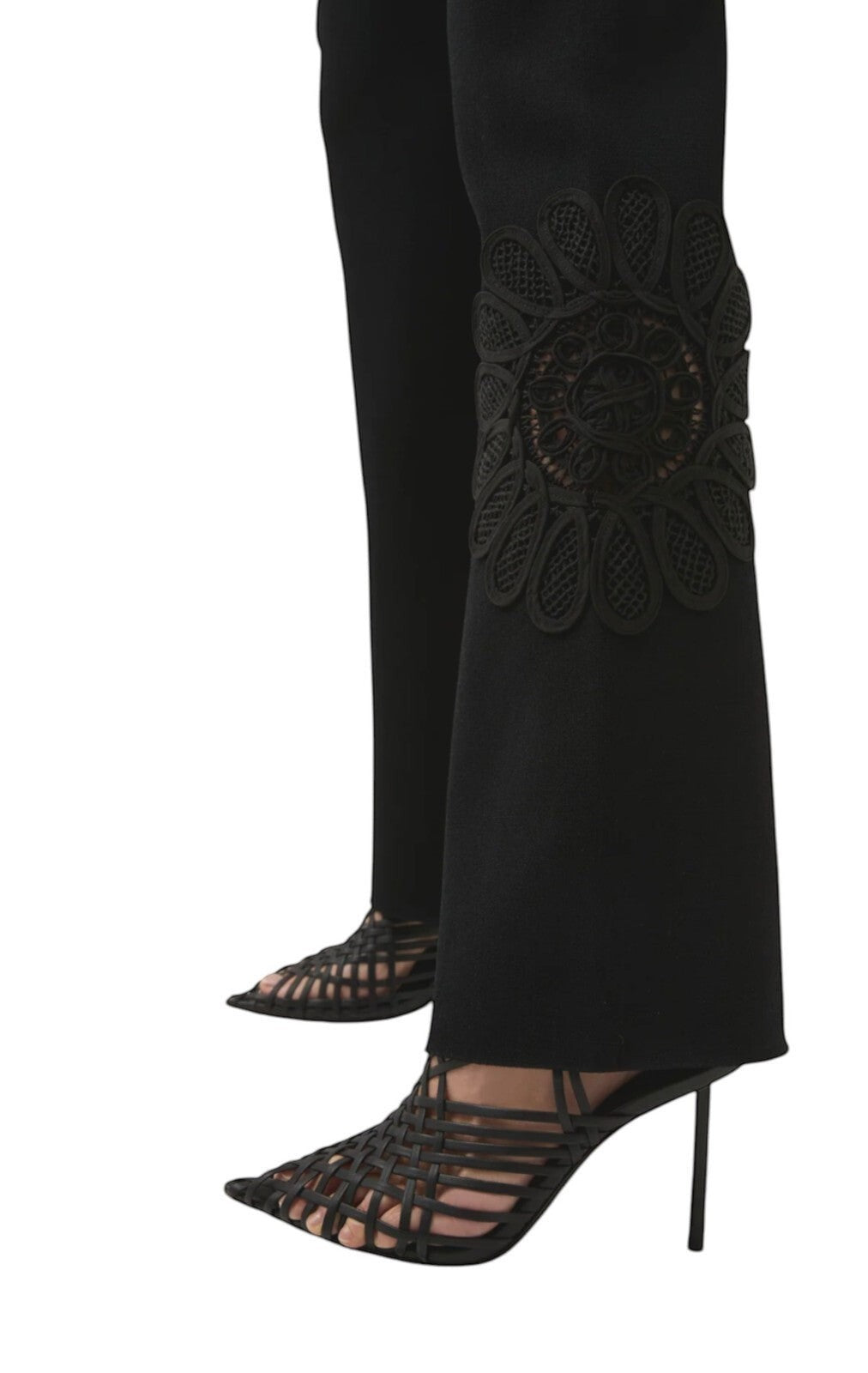Naked Pear Aje black stretch knit pants featuring a high waist, flared silhouette, and intricate lace mandala detail.