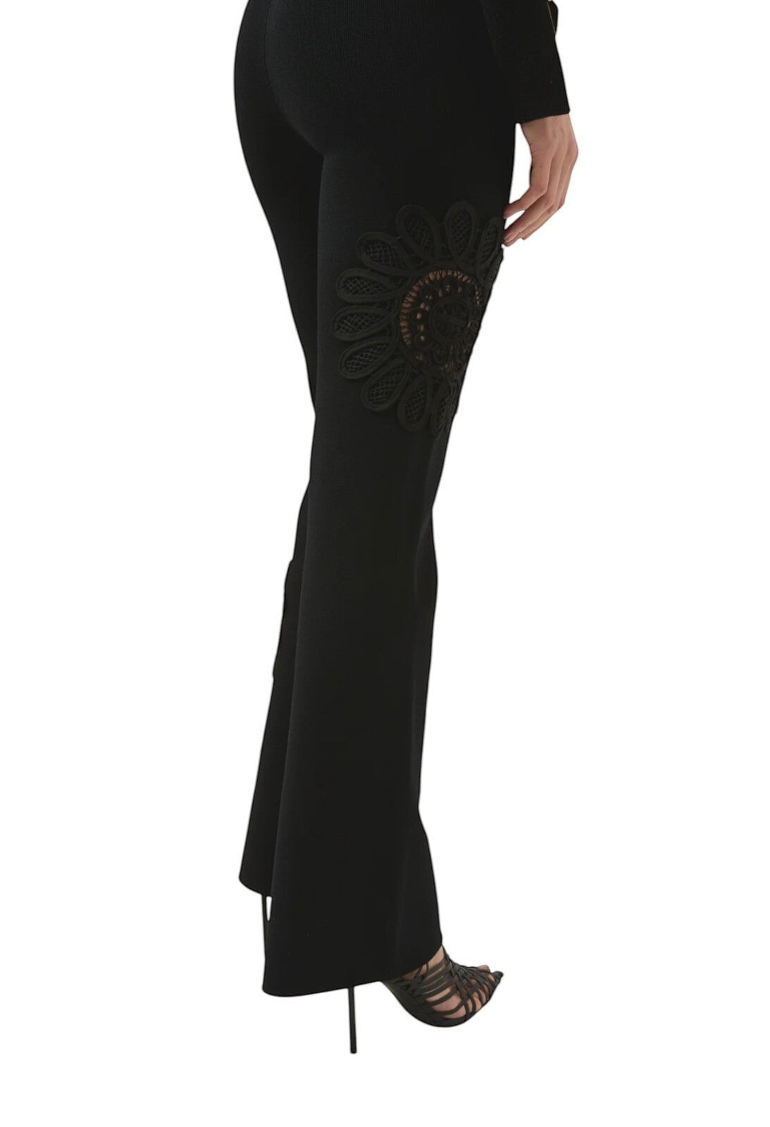 Naked Pear Aje black high-waisted knit pants with flared legs and intricate lace mandala flower detail on the side