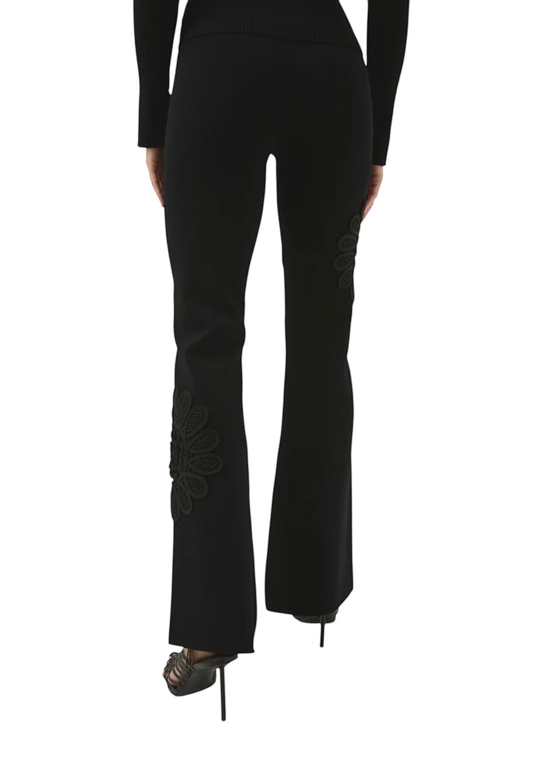 Naked Pear Aje black high-waisted stretch knit pants with flared legs and intricate lace flower detail