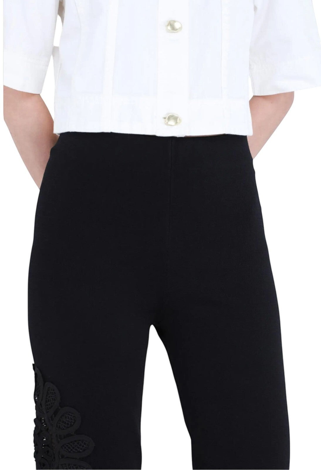 Naked Pear Aje black high-waisted knit pants featuring a flared silhouette and intricate lace flower leg detail.
