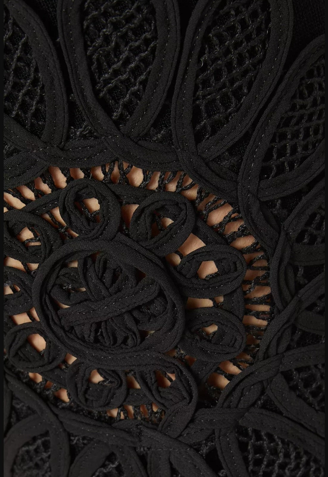 Naked Pear Aje Motion Mandala black knit pants featuring intricate lace flower leg detailing and stretch fabric.