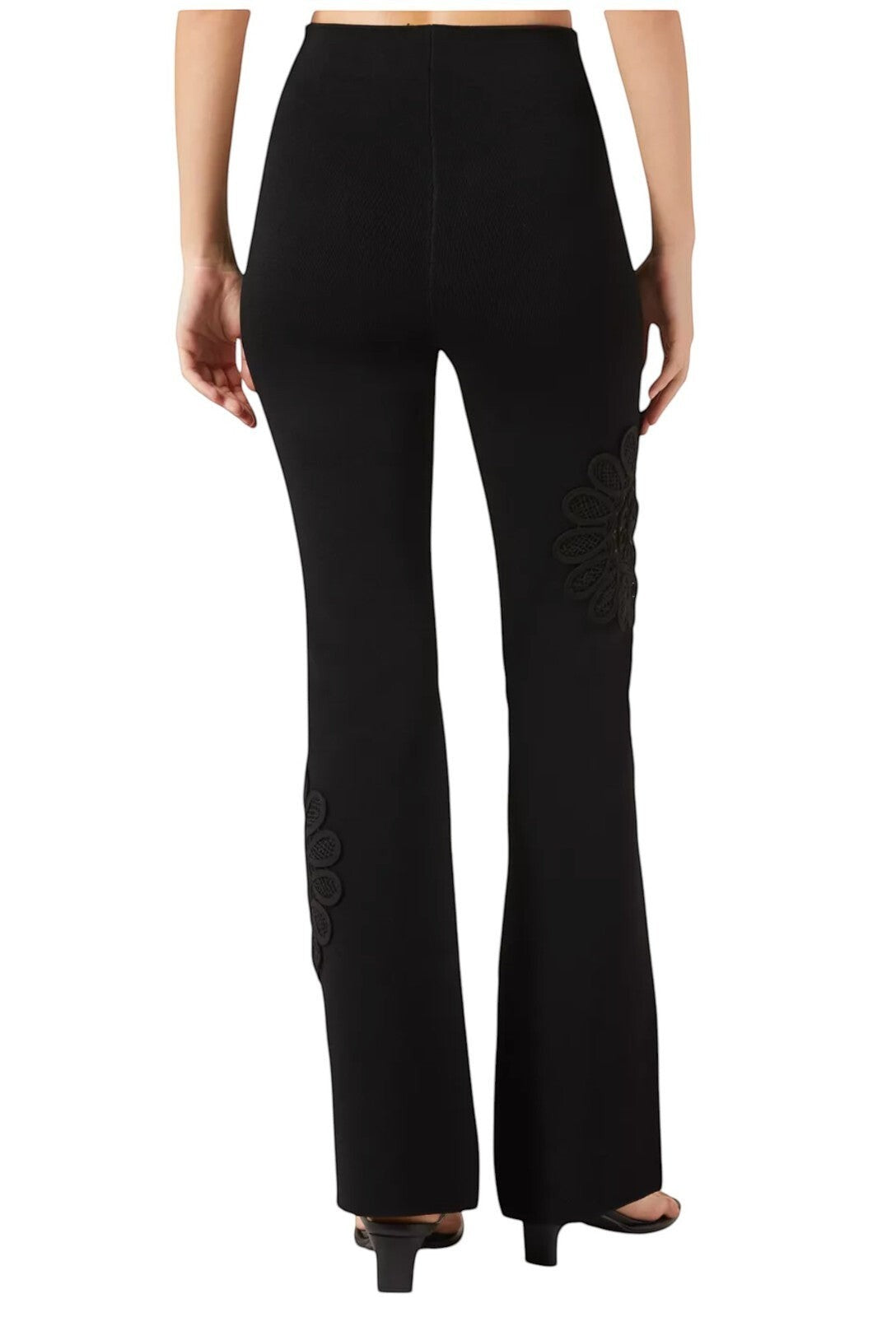 Naked Pear Aje black high-waisted knit pants with flared legs and intricate lace mandala flower detail on the side