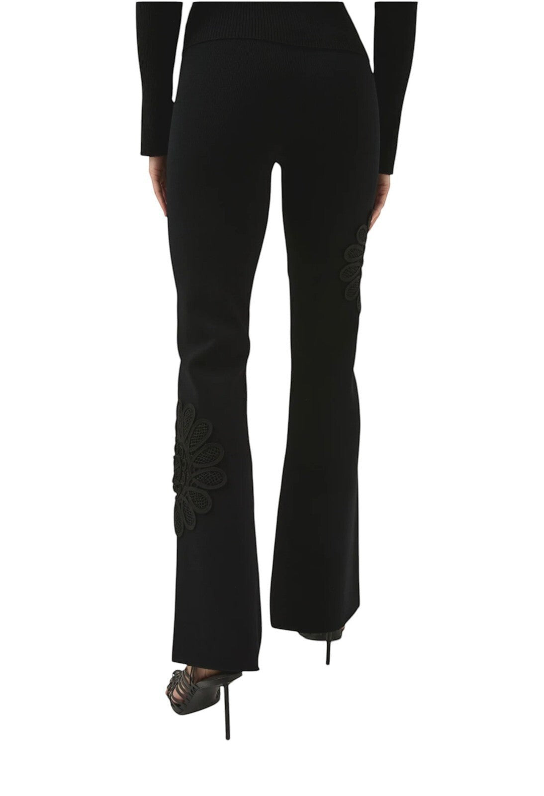 Naked Pear Aje black high-waisted knit pants with flared legs and intricate lace flower detail on the lower leg