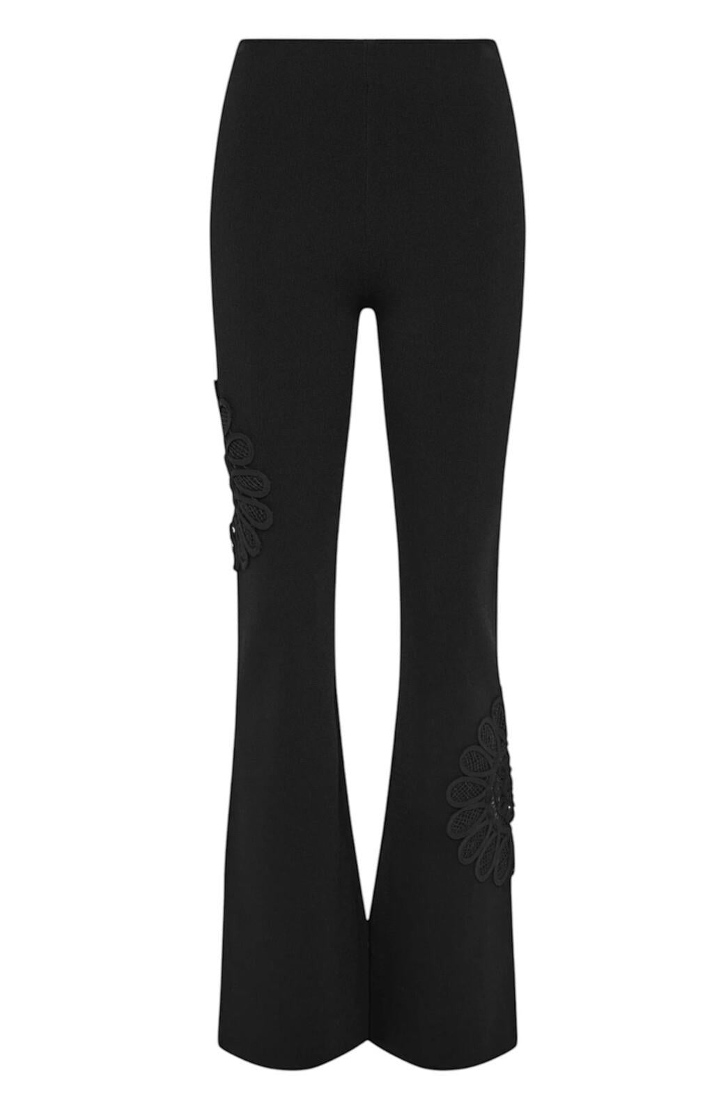 Naked Pear Aje black stretch knit pants with high waist, flared leg, and intricate lace flower detail.