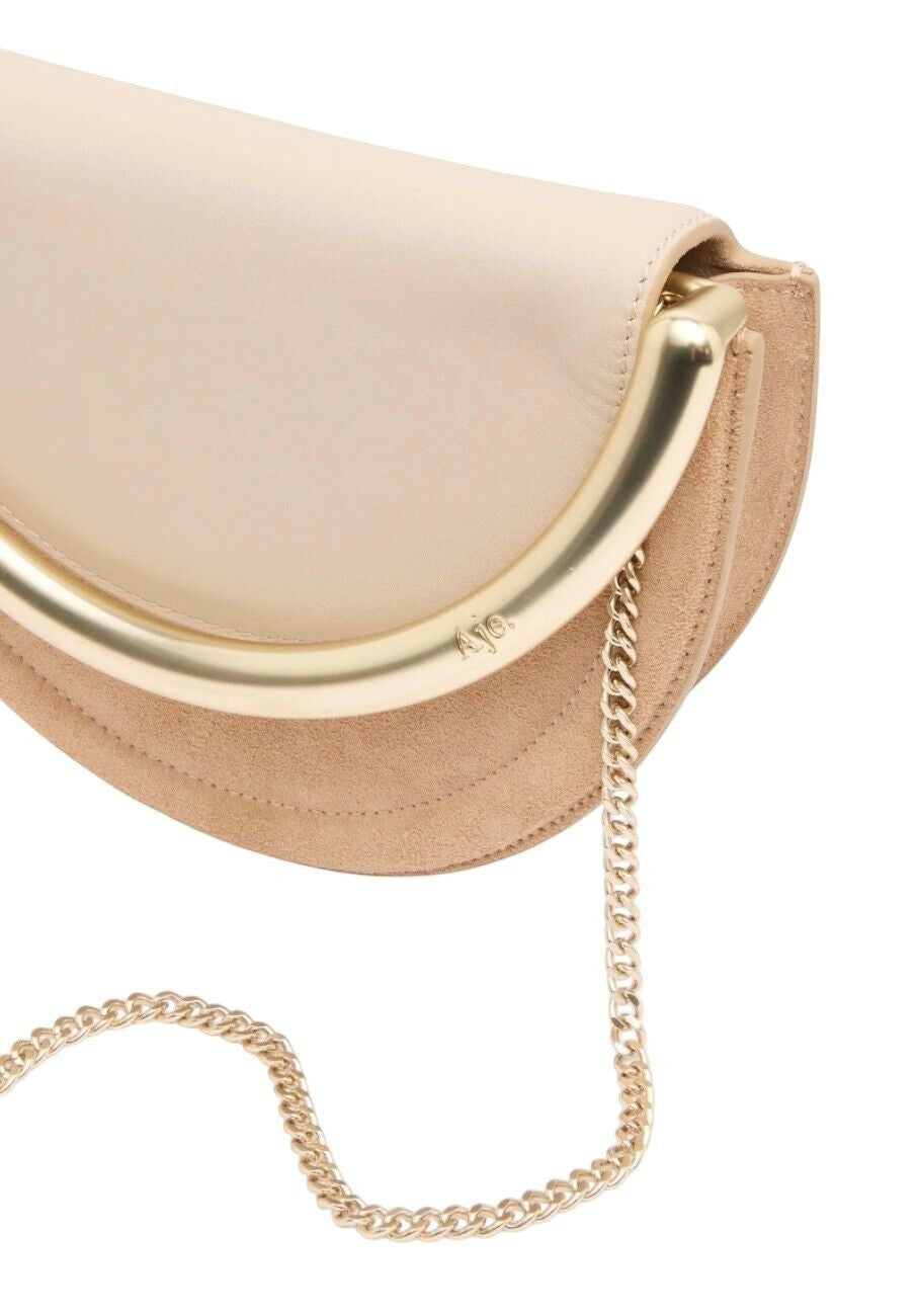 Naked Pear Aje Norma crescent crossbody bag in beige suede and leather with a gold metal handle and chain strap.