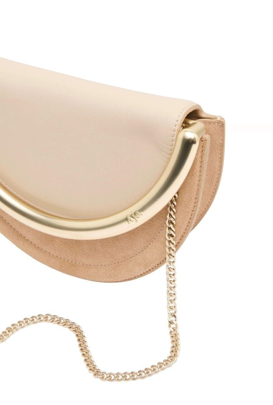 Naked Pear Aje Norma crescent crossbody bag in beige suede and leather with a gold metal handle and chain strap.