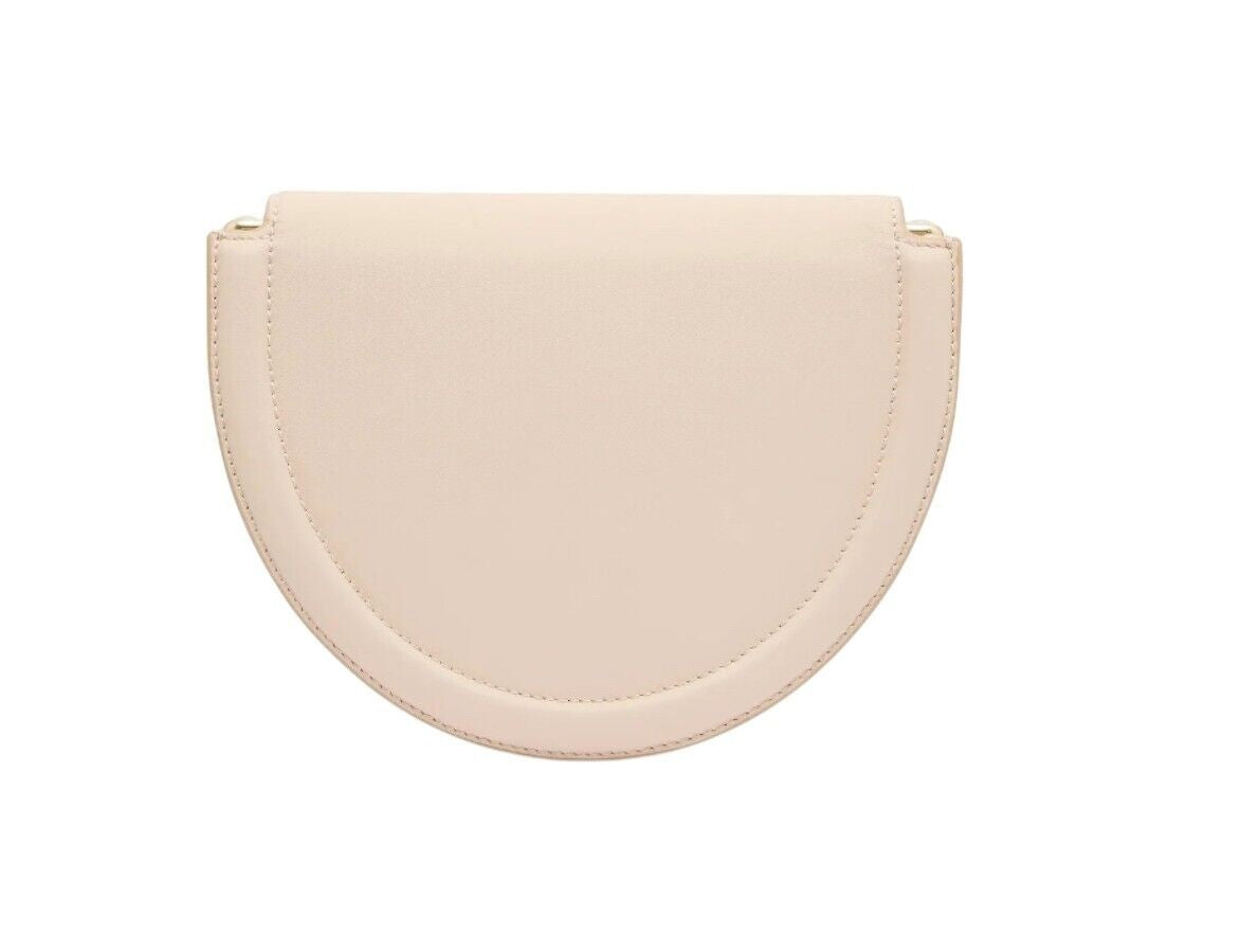 Naked Pear Aje Norma crescent crossbody bag in natura beige suede leather with a minimalist curved silhouette.