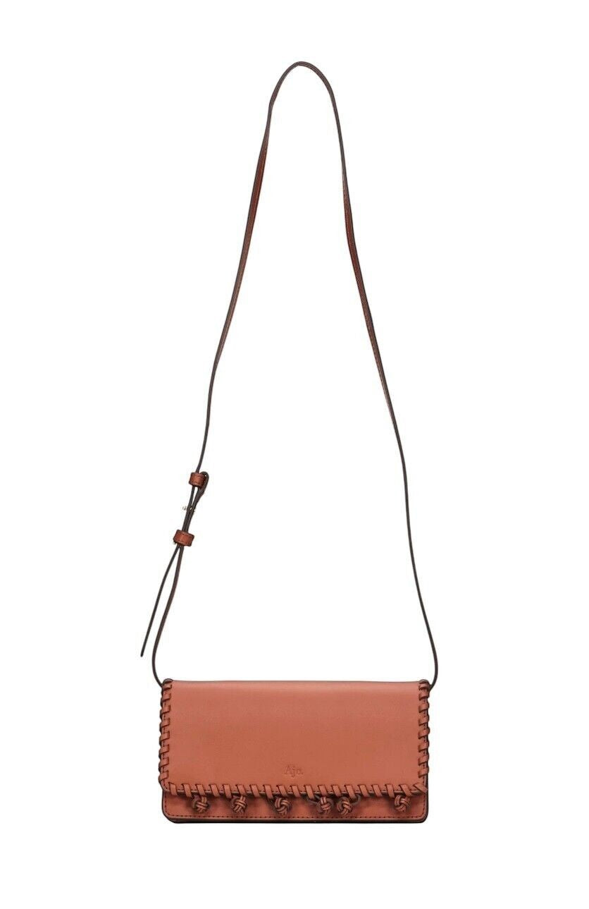 Naked Pear Aje Tasselate tan leather crossbody bag with decorative pom-pom trim and adjustable shoulder strap
