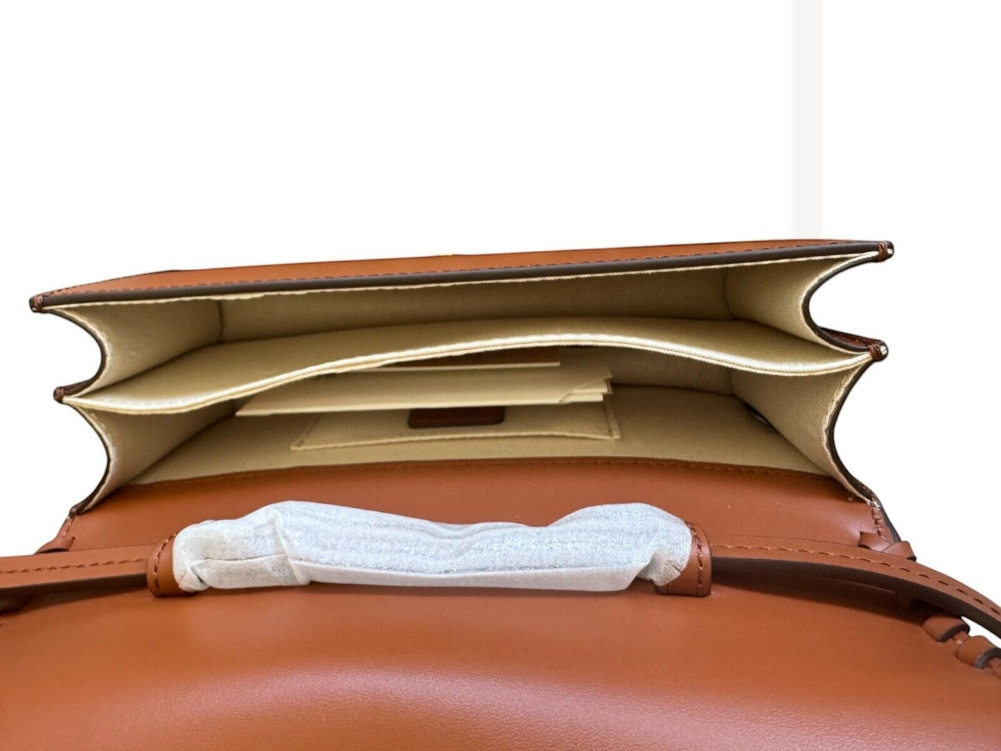 Naked Pear Aje Tasselate tan leather crossbody bag interior showing twin compartments and internal slide pocket