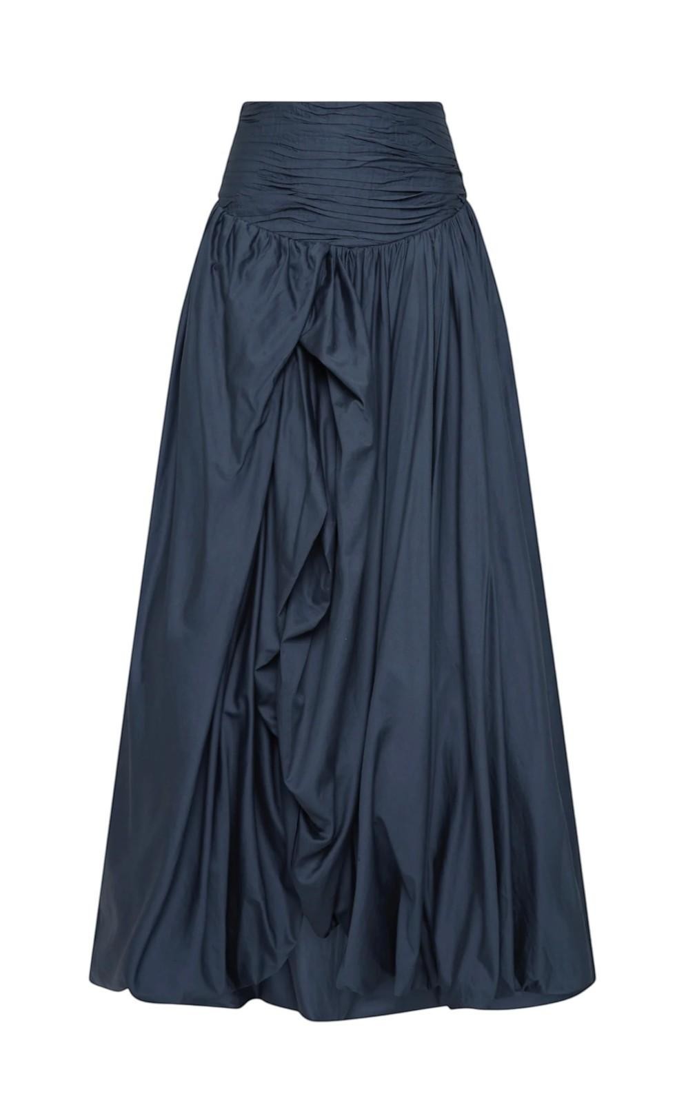 Naked Pear Aje Violette slate blue cotton maxi skirt with ruched waist, asymmetric draping, and bubble hem.