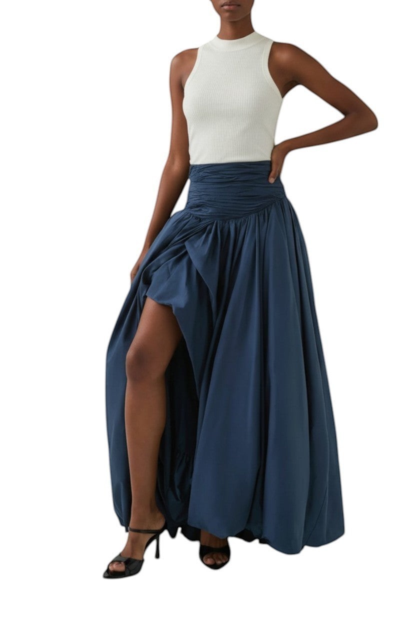 AI generated image of Naked Pear Aje Violette slate blue cotton maxi skirt with ruched waist, asymmetric bubble hem, and front leg slit.