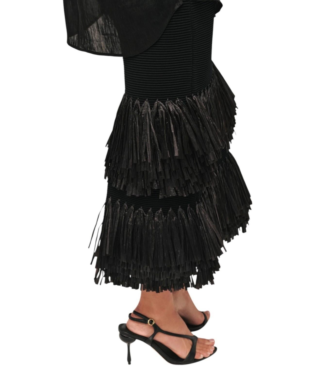 Black fringe skirt worn by a person on a white background