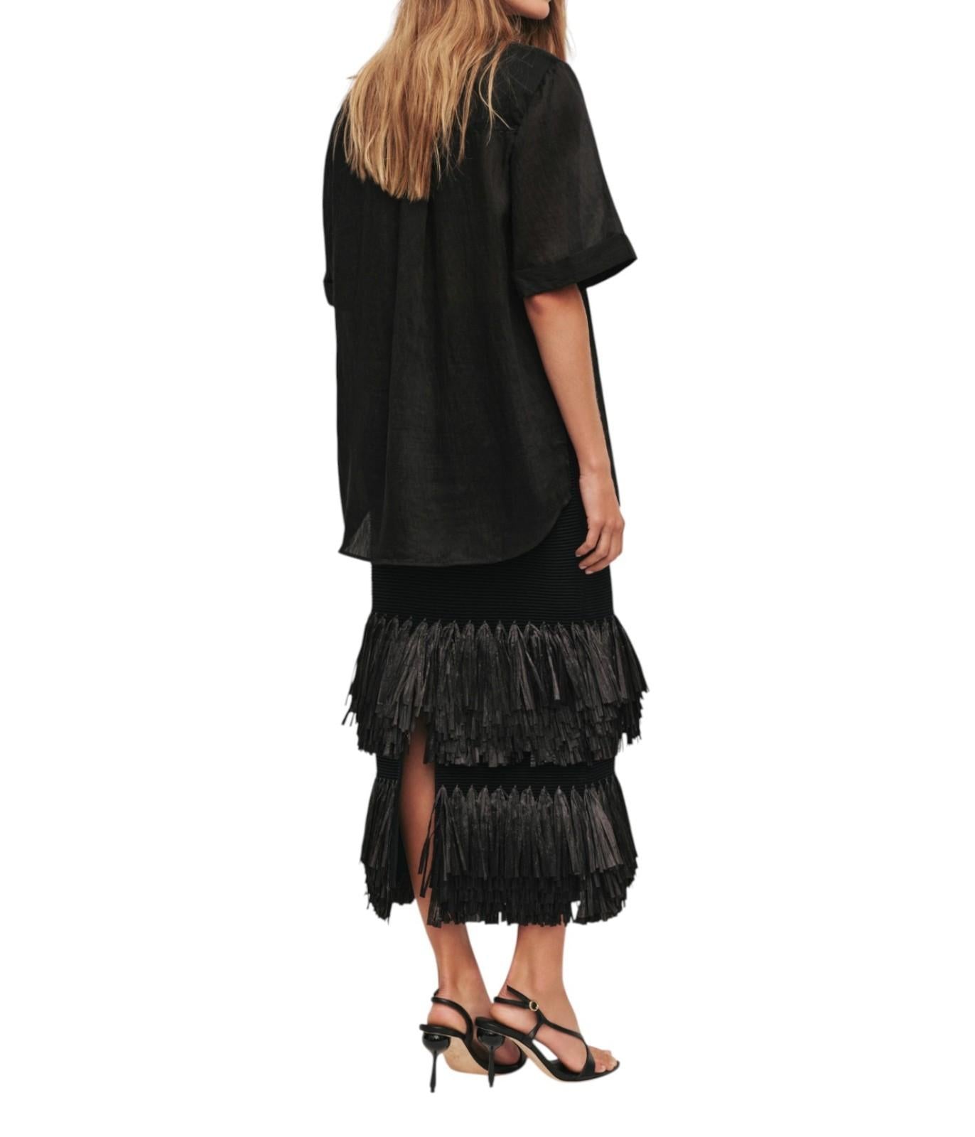Black dress with tiered frill skirt on a white background