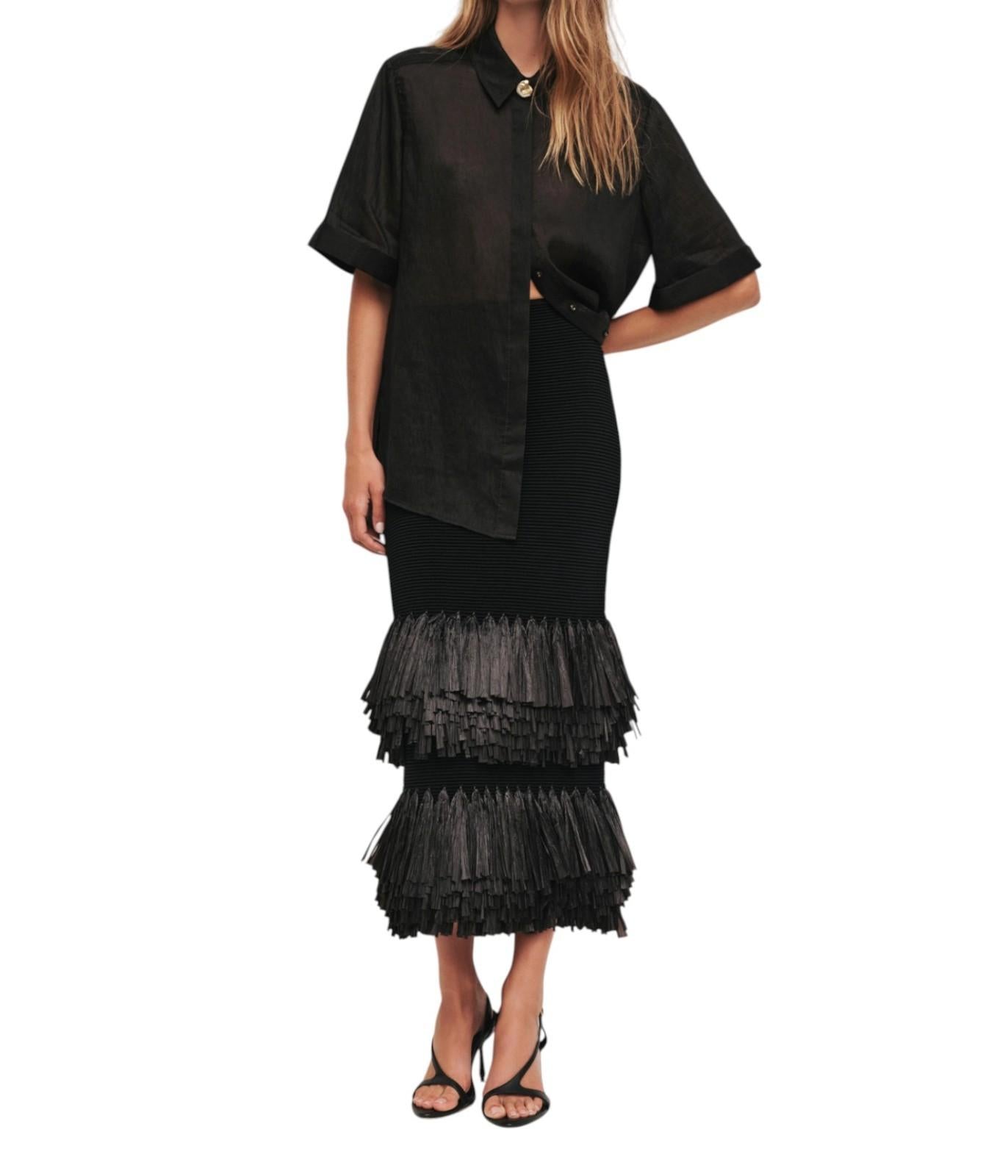 Black dress with ruffled skirt on a white background