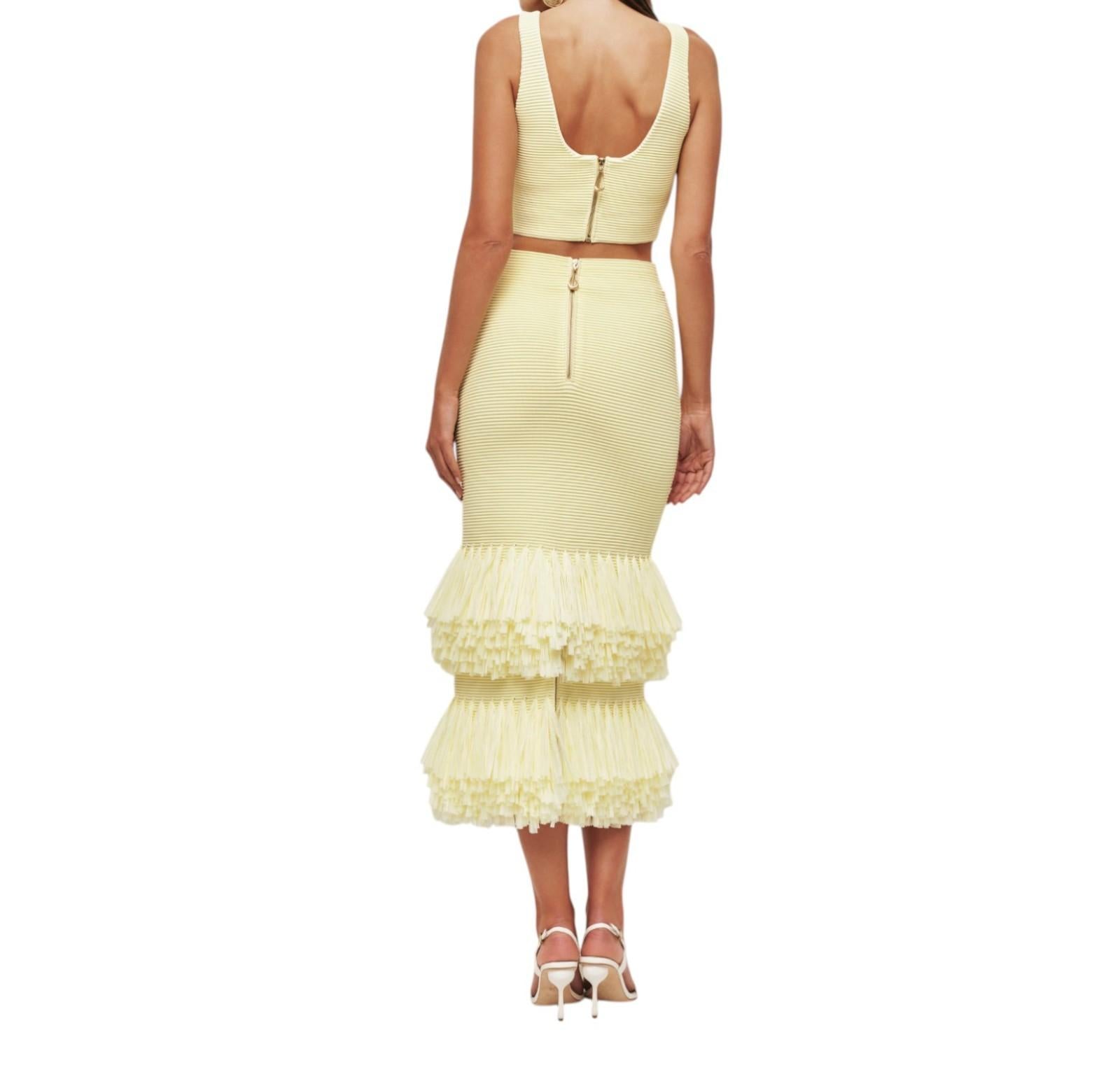 Yellow dress with ruffled skirt on a white background