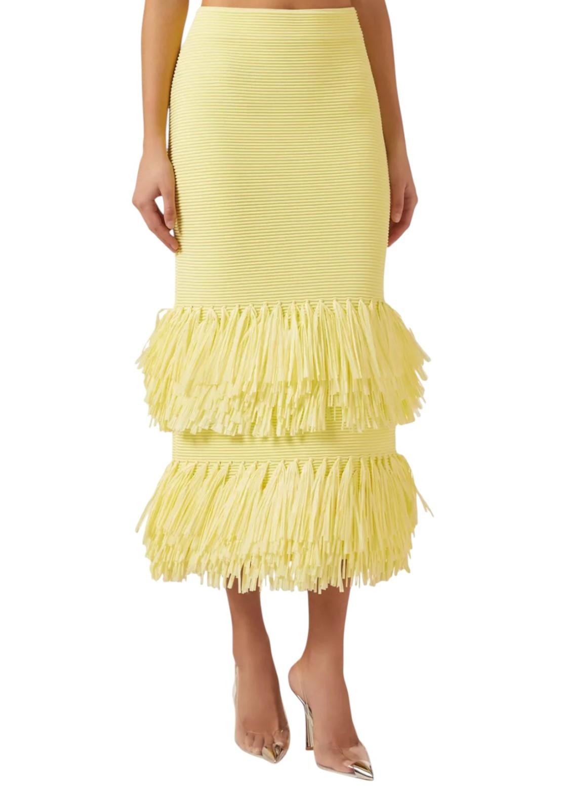 Yellow ruffled skirt worn by a person on a white background