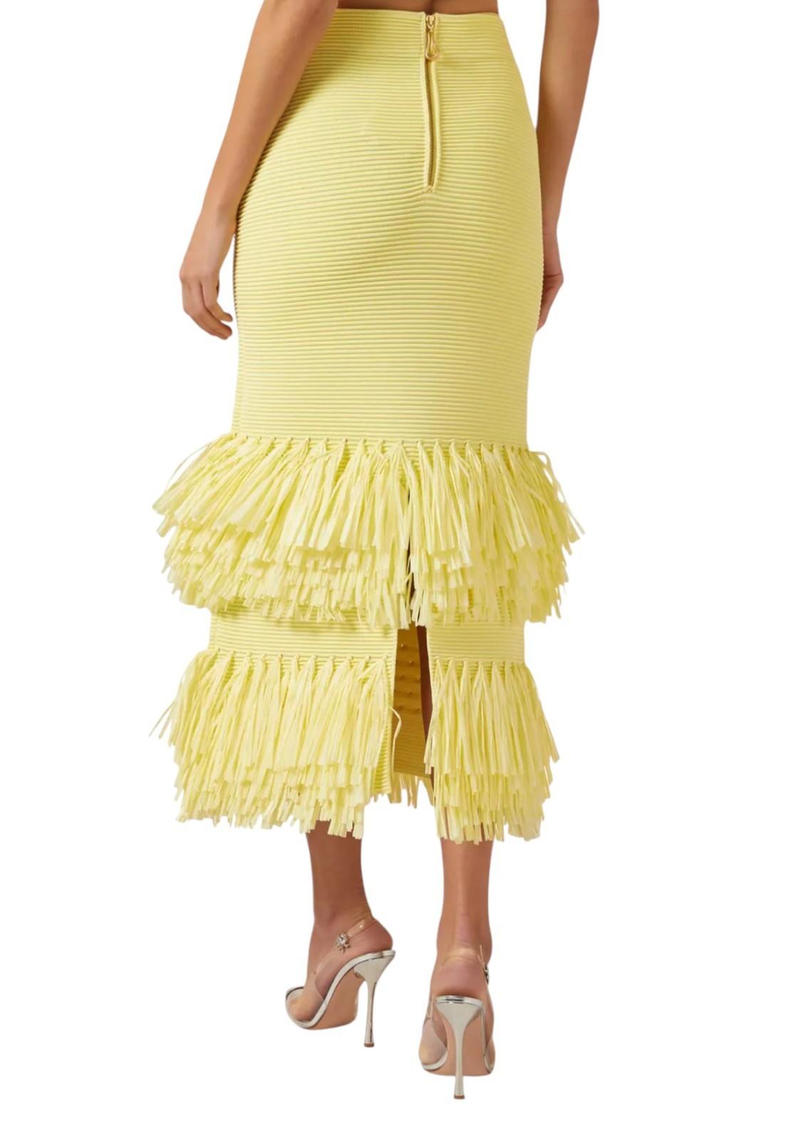 Yellow ruffled skirt worn by a person on a white background