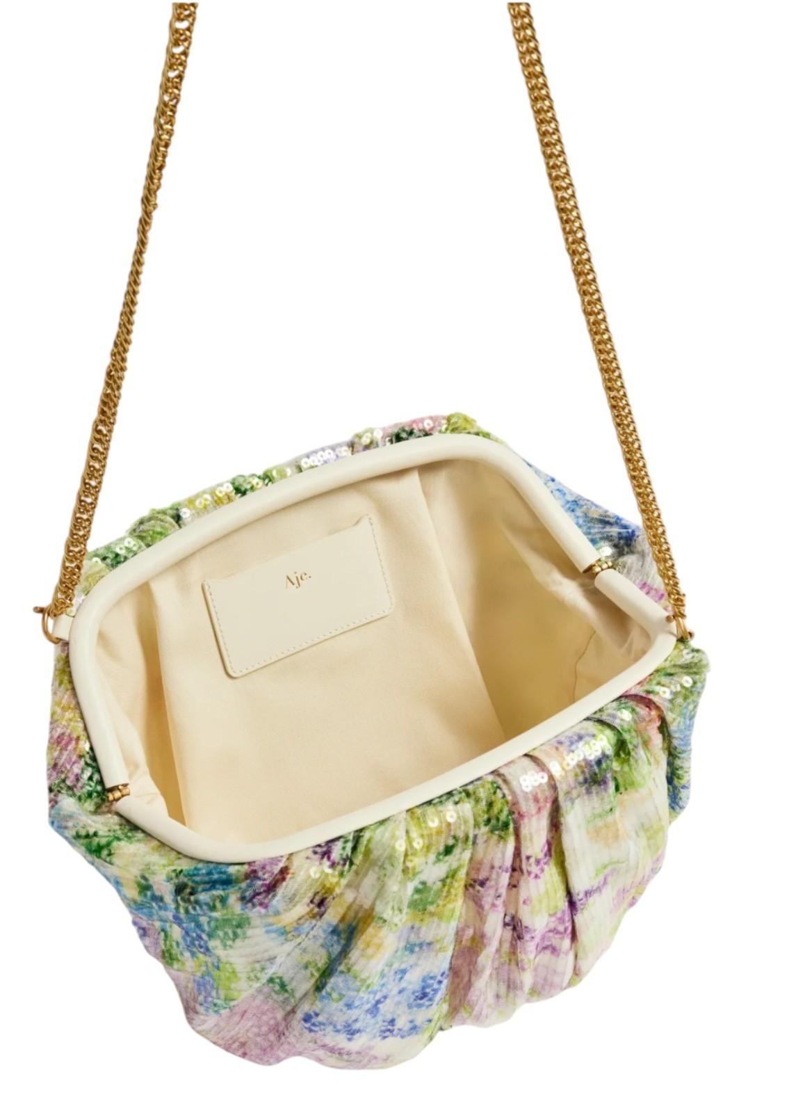 Floral-patterned handbag with a gold chain strap on a white background