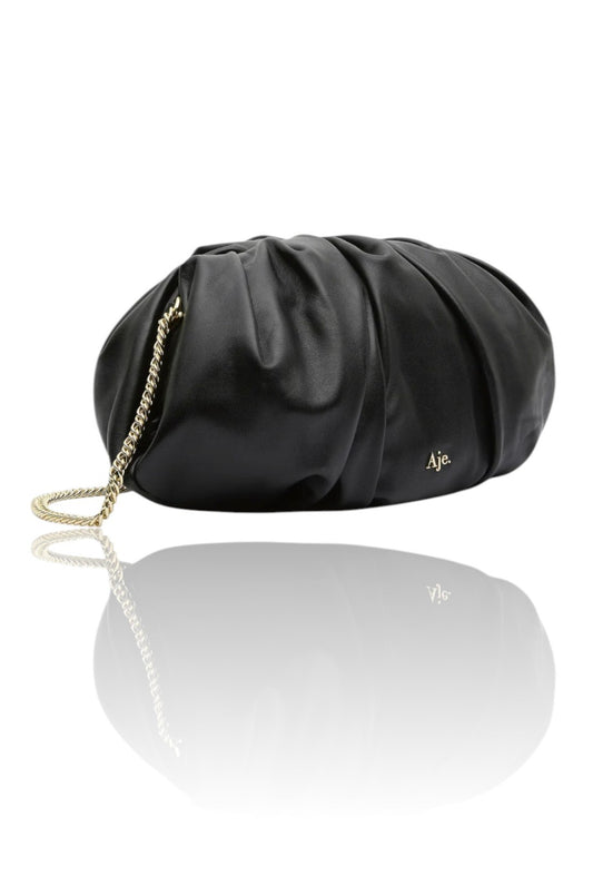 Black clutch bag with chain detail on a white background