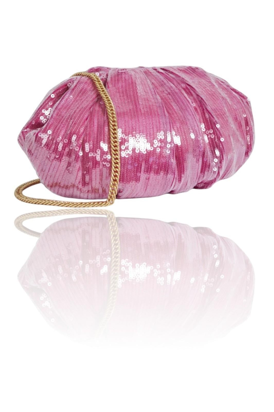 Pink sequined clutch bag with a gold handle on a white background