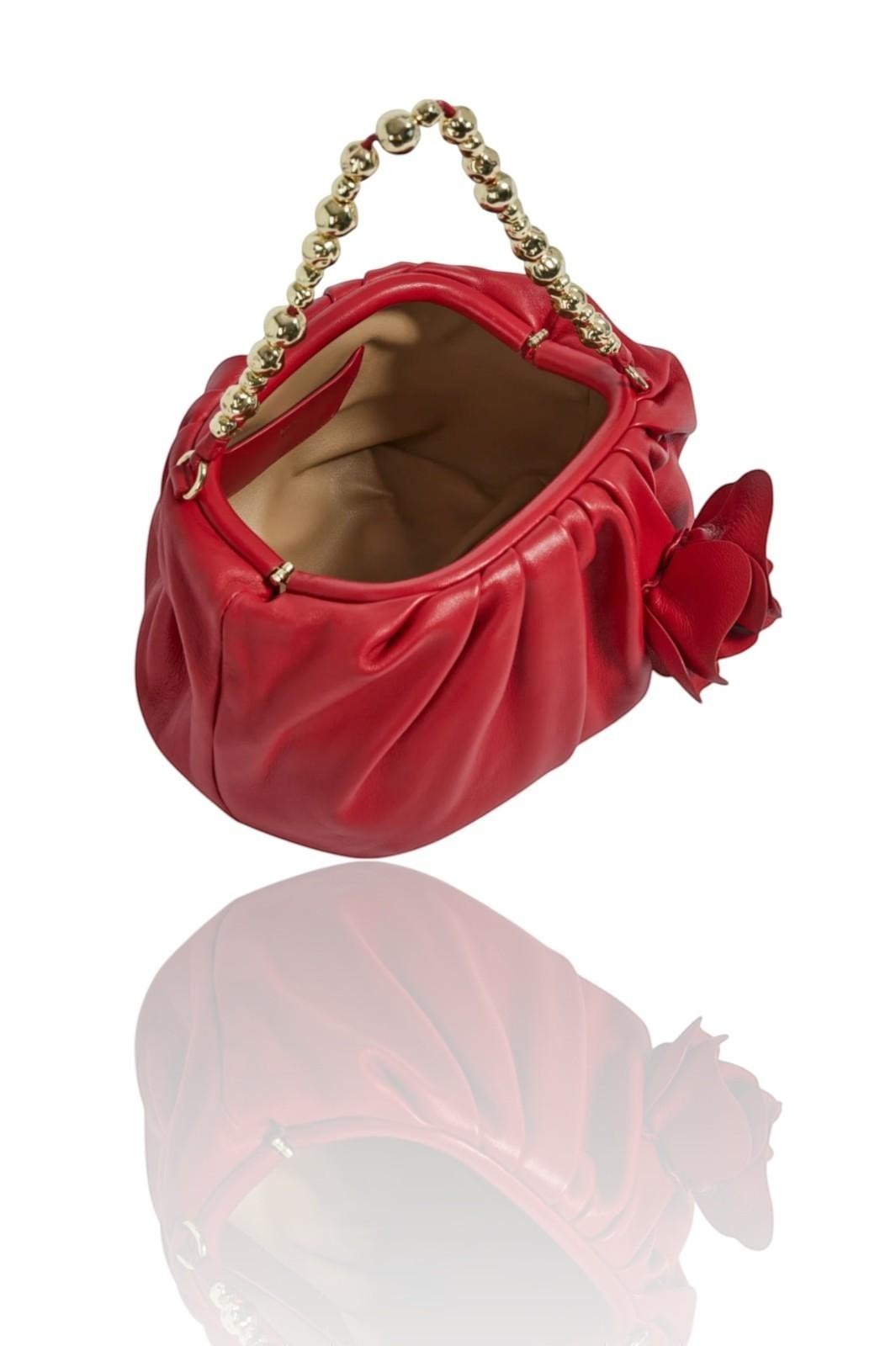 Red handbag with a gold chain handle on a white background