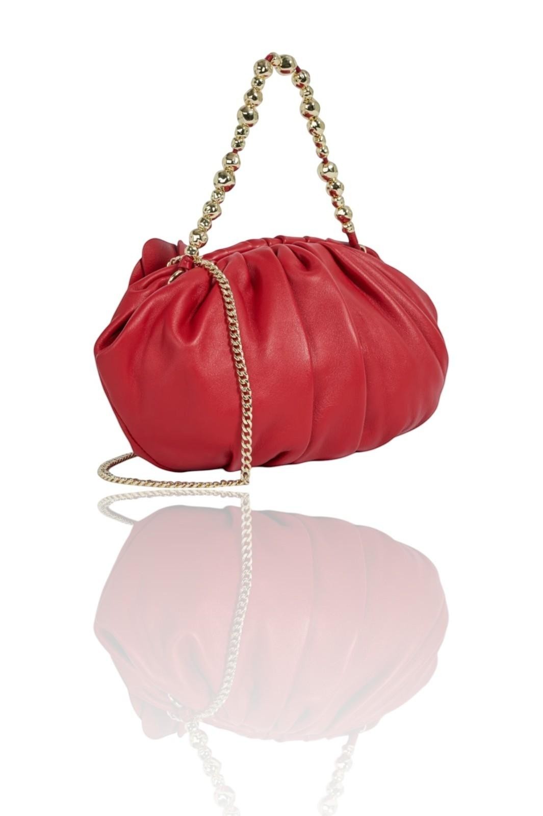 Red handbag with a gold chain handle on a white background