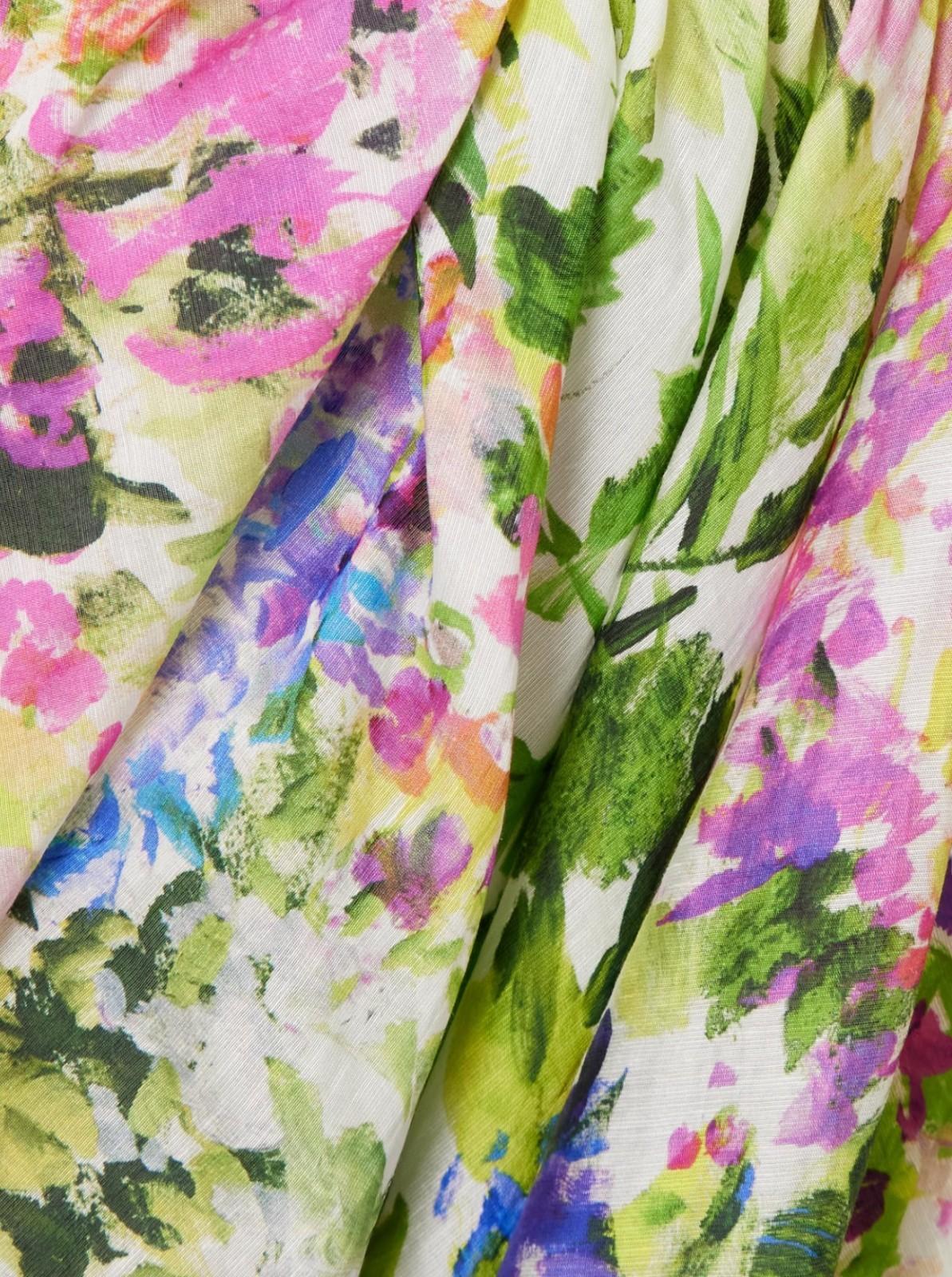 Close-up of colorful floral fabric with pink, green, and purple flowers.