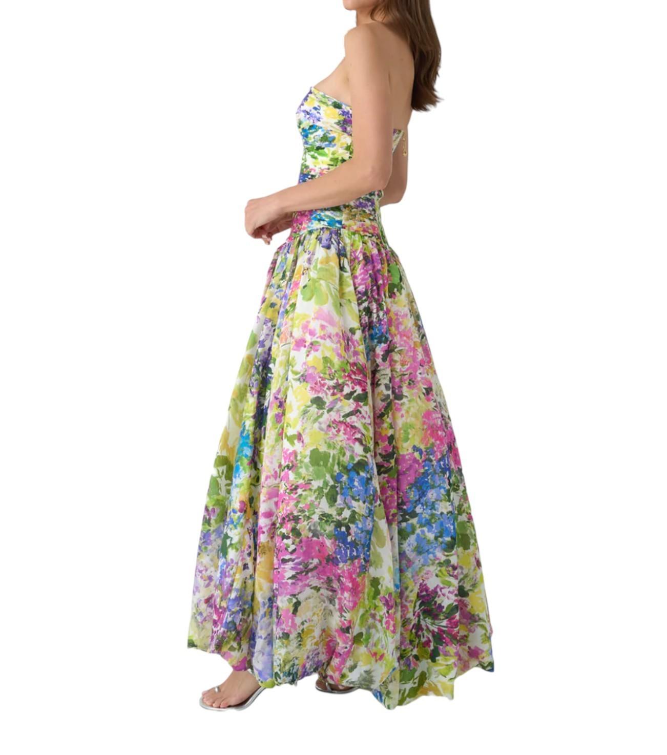 Woman wearing a colorful floral dress on a white background