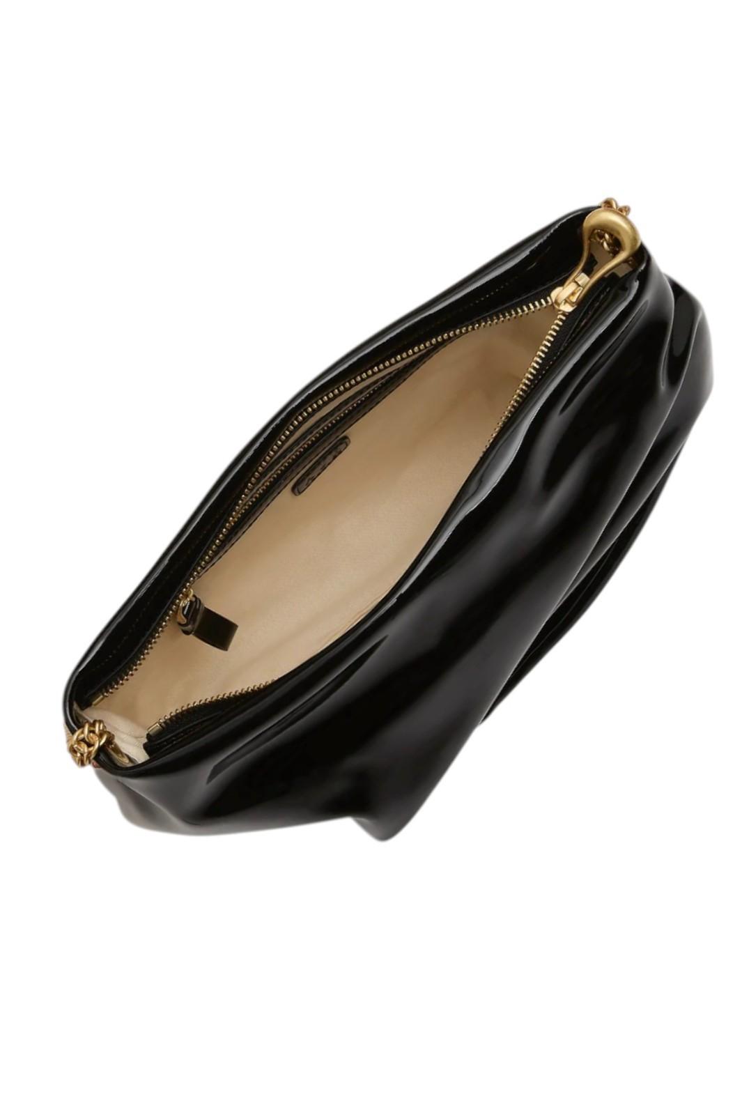 Black clutch bag with gold zipper on a white background